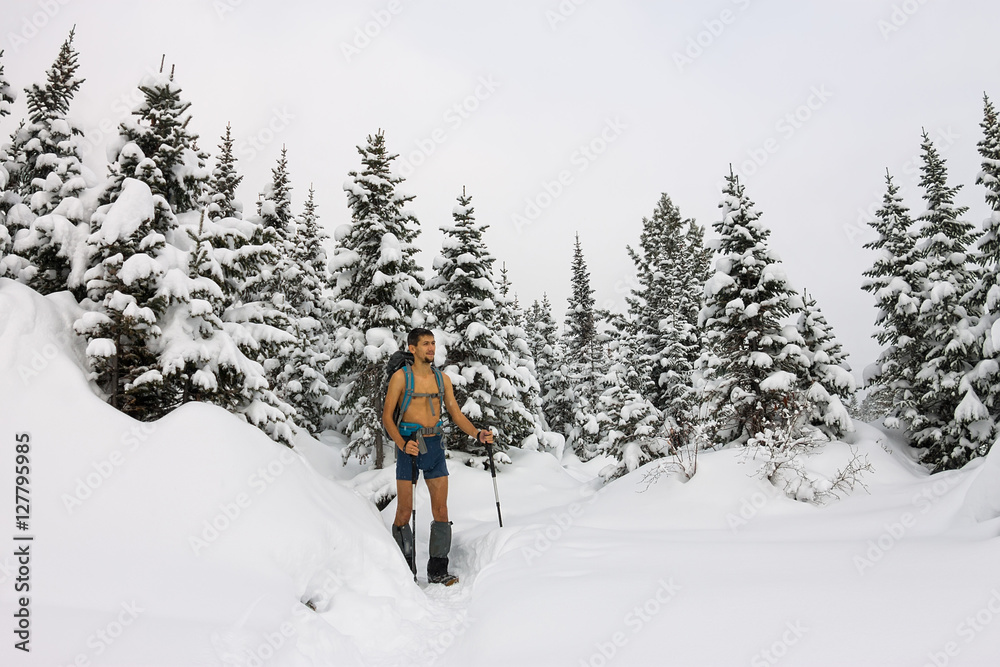 Male tourist with a backpack, with a naked torso and legs is amo