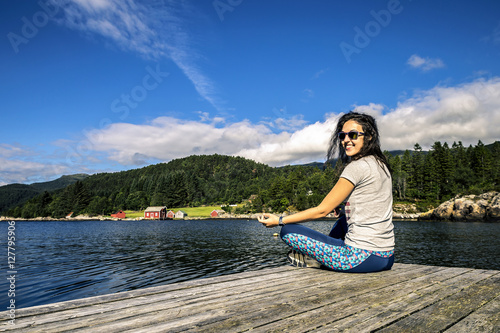 Young woman enjoying the sunny day on the fjord, Norway © bint87