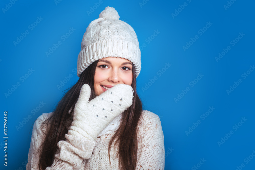 Love winter. Pretty young happy woman in winter clothes Woman surprise showing product .Beautiful girl with curly hair pointing to the side . Presenting your product Love winter. Pretty young happy woman in winter clothes Woman surprise showing product .Beautiful girl with curly hair pointing to the side . Presenting your product