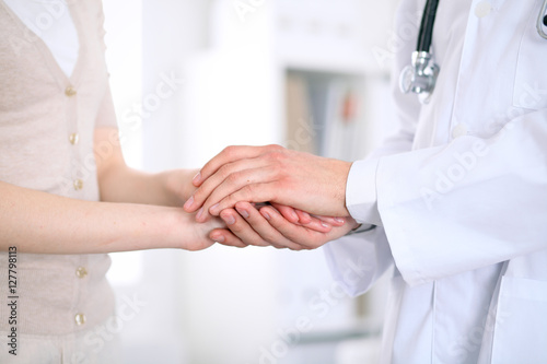 Hand of doctor reassuring her female patient © rogerphoto
