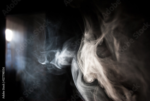 Fluffy Puffs of Smoke and Fog on Black Background