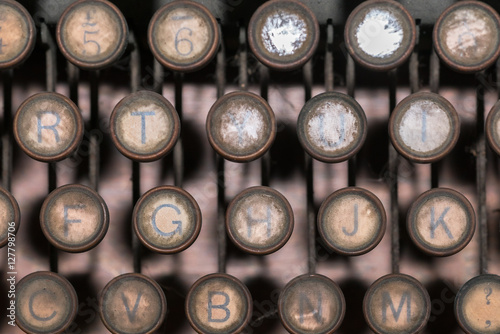 Close-up of a dark and rusty vintage typewriter.  