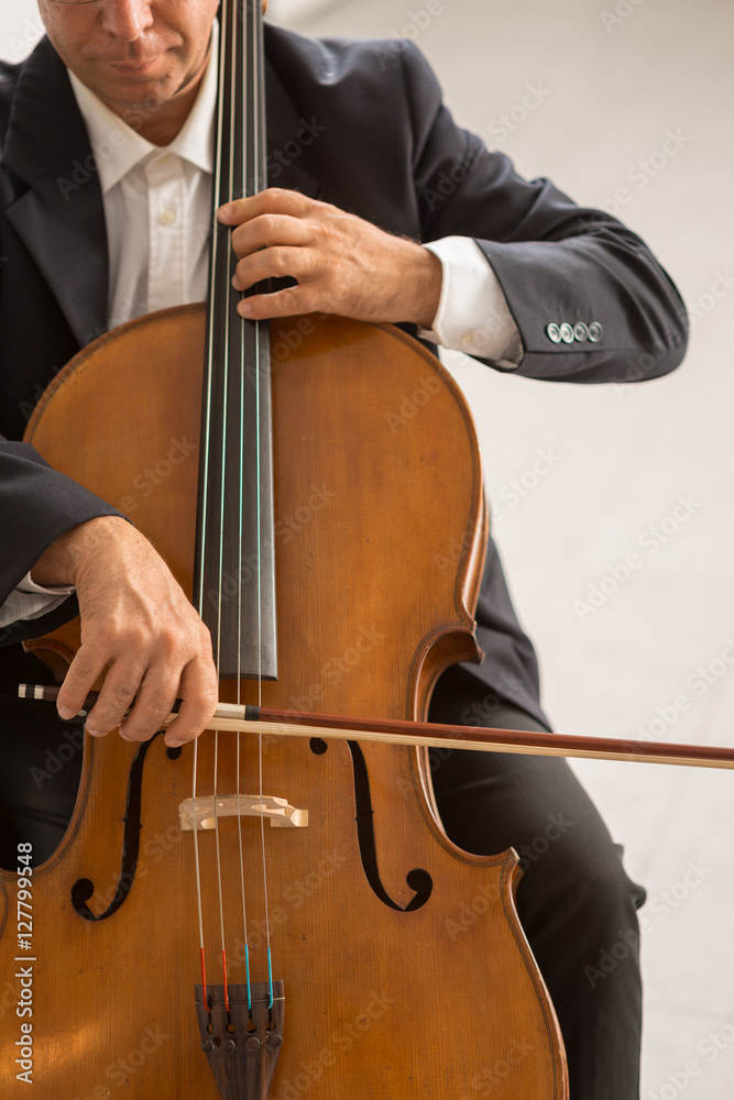 Professional cellist playing his instrument Professional cellist playing his instrument