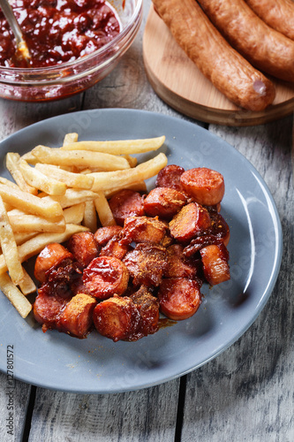Traditional German currywurst - pieces of sausage with curry sauce