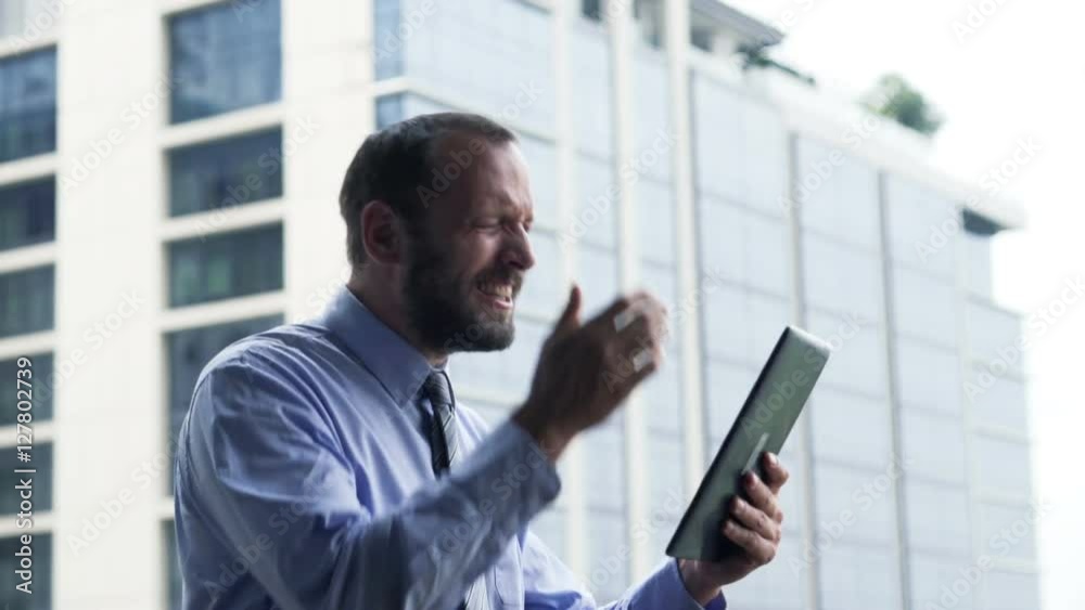 Unsuccessful businessman with tablet getting bad news standing on terrace
Unsuccessful businessman with tablet getting bad news standing on terrace