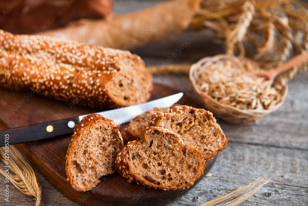 Sliced rye bread on a Board. On a wooden rustic table. Sliced rye bread on a Board. On a wooden rustic table.