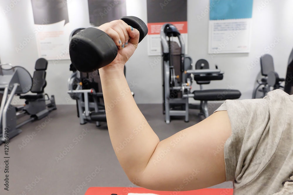 Hands holding dumbbells in sport club or gym and fitness room. Hands holding dumbbells in sport club or gym and fitness room.