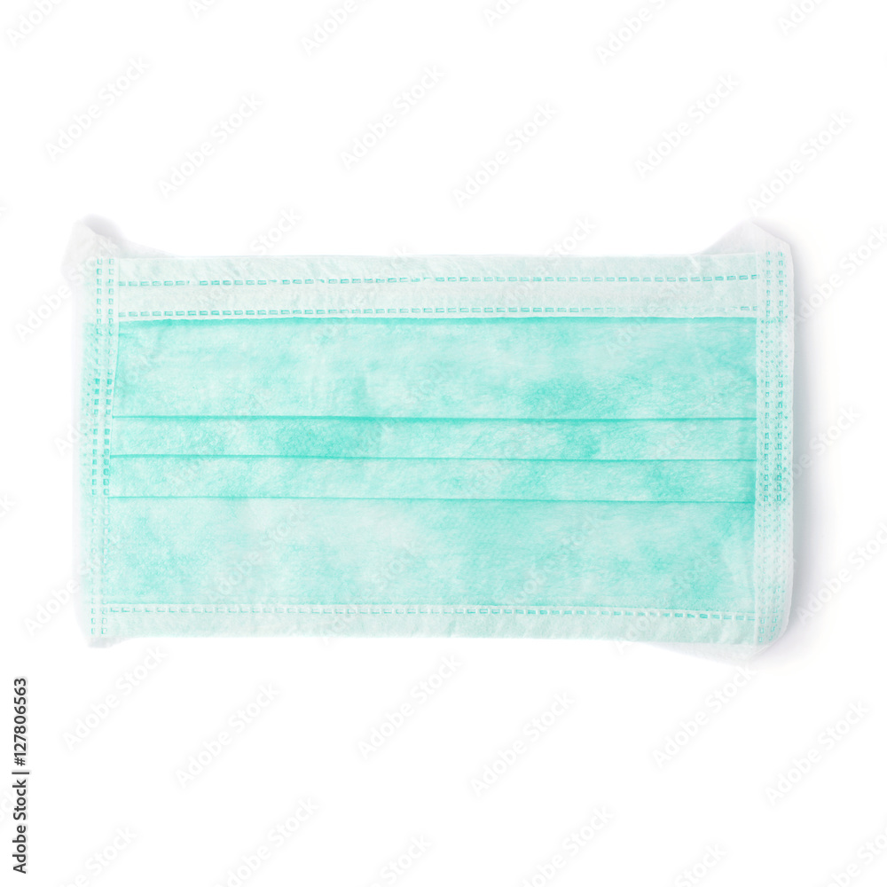 Green medical surgical rotective mask over isolated white background
