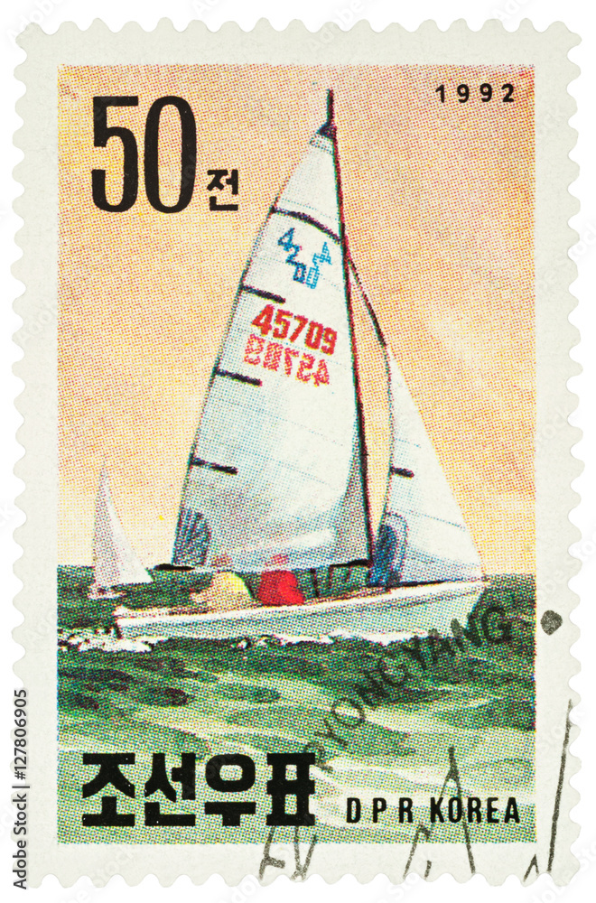 Fototapeta premium Sailing yacht on postage stamp