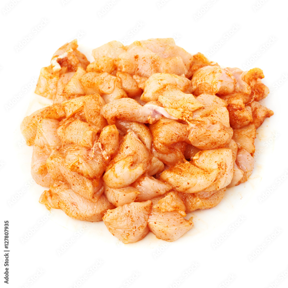 Raw chicken fillet cutted into pieces and spiced isolated over white background Raw chicken fillet cutted into pieces and spiced isolated over white background