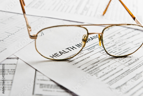 Health insurance claim form with glasses