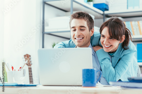 Young couple surfing the web at home