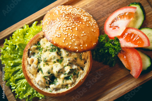 Julienne in a bun for a Burger on wooden background