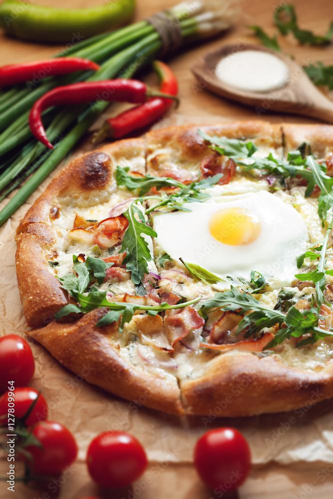 Fresh pizza with ingredients on wooden table Fresh pizza with ingredients on wooden table