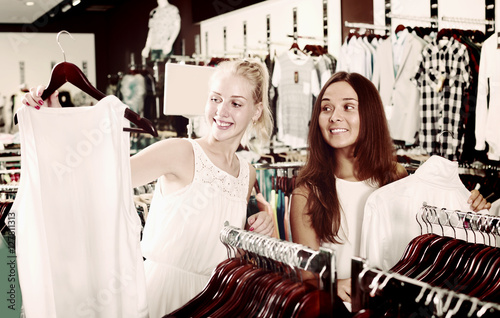 Two positive girls shopping top together