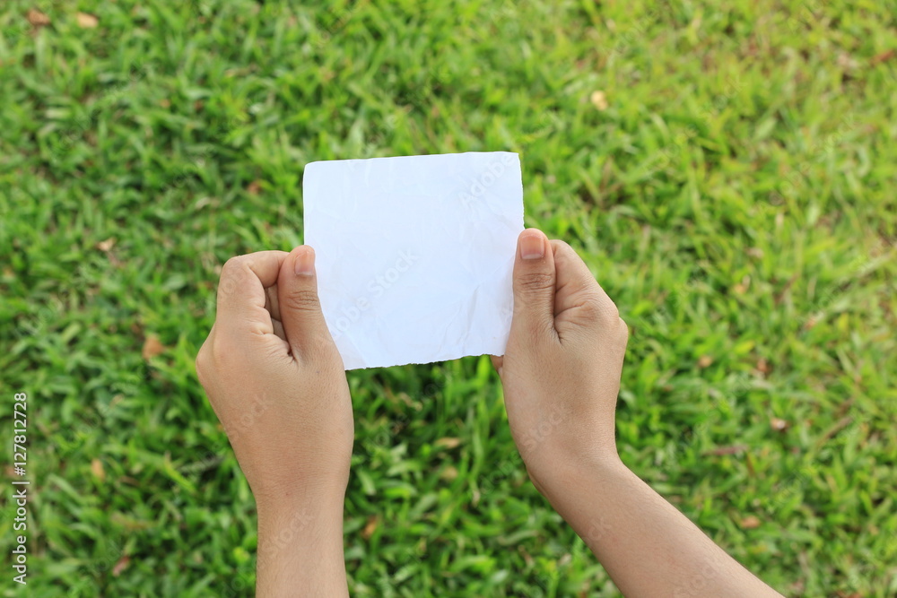 close up of a hand holding blank note paper close up of a hand holding blank note paper