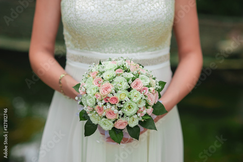Wedding bouquet in the hands of the bride