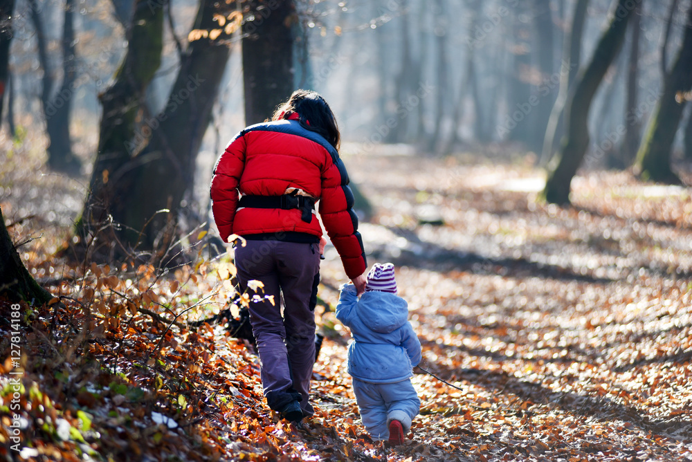 Mother with her child walking in the forest Mother with her child walking in the forest