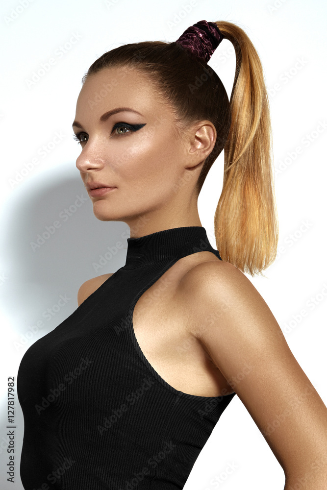 Fashion portrait of beautiful young woman with ponytail hairstyle. Beauty  shot of sexy girl on white background. Pony tail straight hair, catwalk  black eyeliner makeup on model face Stock Photo | Adobe