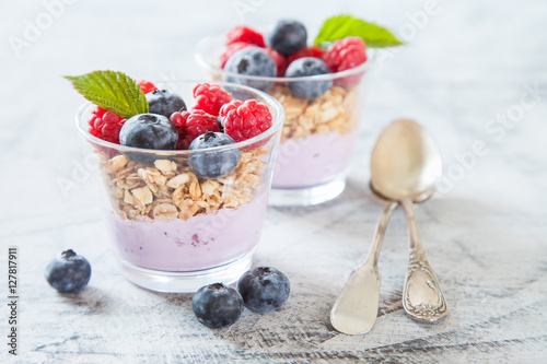 yogurt and muesli with berries on a table, selective focus,