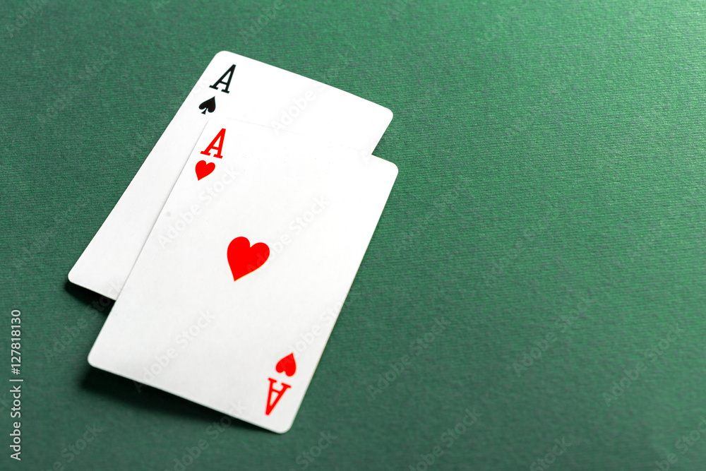 Cards and chips for poker on green table