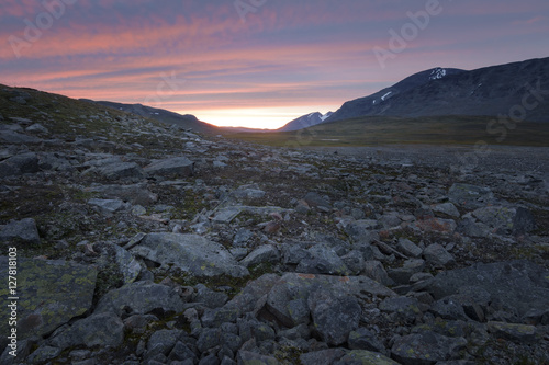 Bright colored striped sunset over the harsh rocky Sarek landscape photo