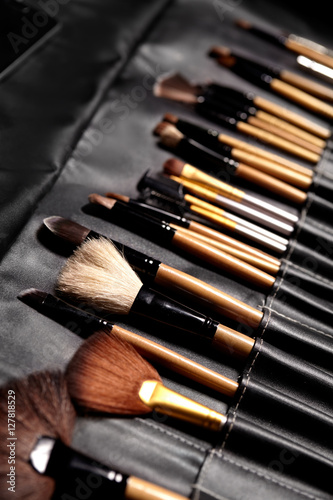 Set of make-up brushes in black makeup bag. Beauty tools for professional visage. Brushes for maskara, eyeshadows, foundation, lipstick, blush and facial cream