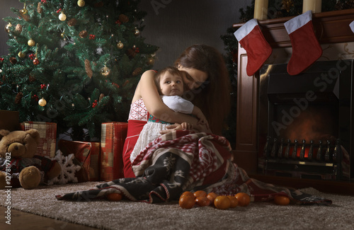 Mother with little girl  in the room with Christmas decorations