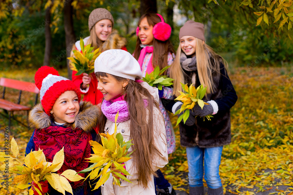 group of girls in autumn park with leafs group of girls in autumn park with leafs