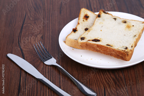 French toast on a white plate with fork.