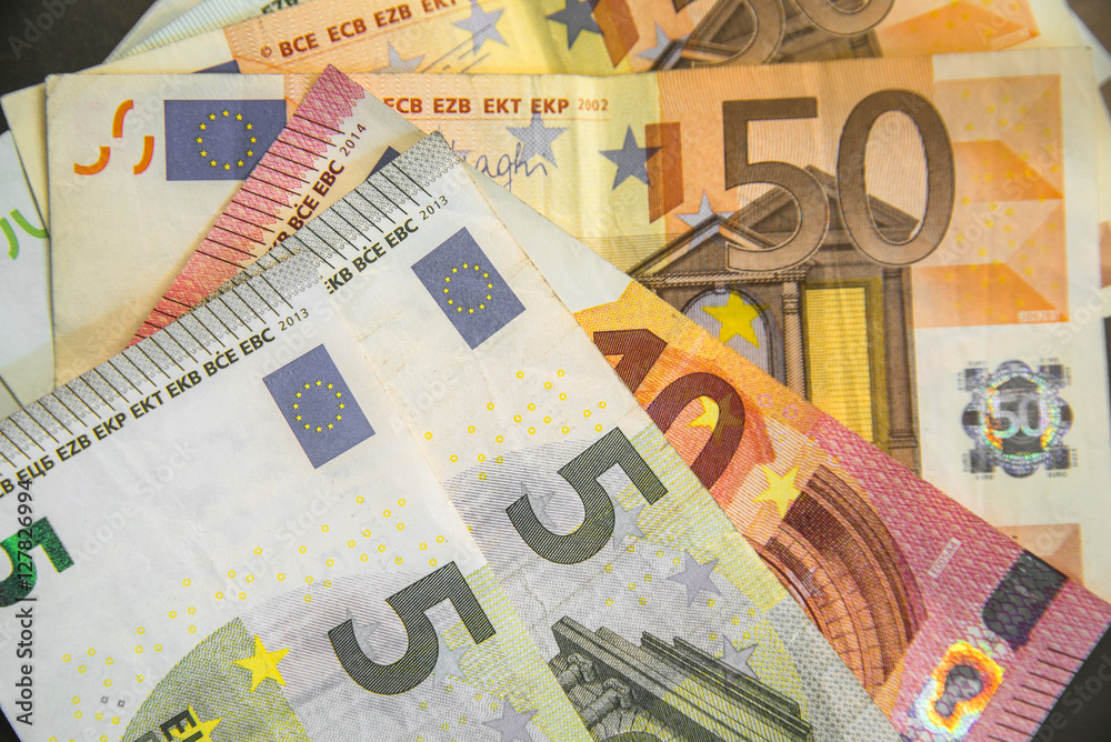 Businessman holding ten euro, closeup shot. Male hand holding ten euros Businessman holding ten euro, closeup shot. Male hand holding ten euros