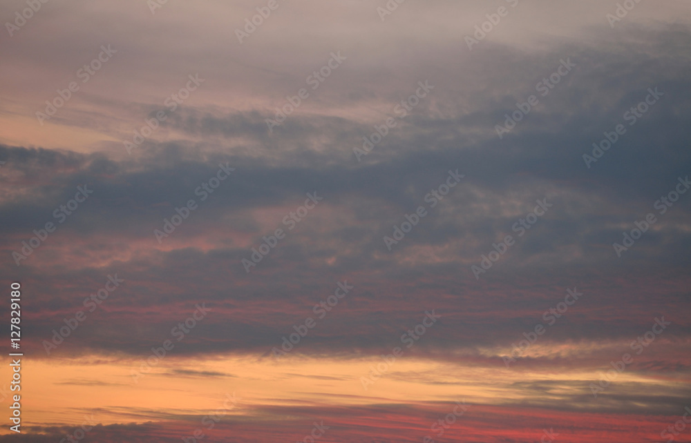 Orange, red, grey sky with clouds at sunset