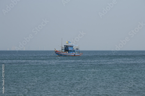 Thai fish boat in the sea with skyscrapers of Pattaya as a background © Alexander Lebedev