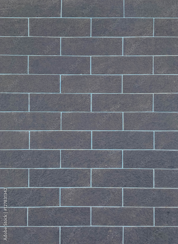 Naklejka premium Closeup surface brick pattern at old black stone brick wall textured background