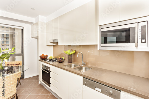 Kitchen with luxurious tools and white walls.