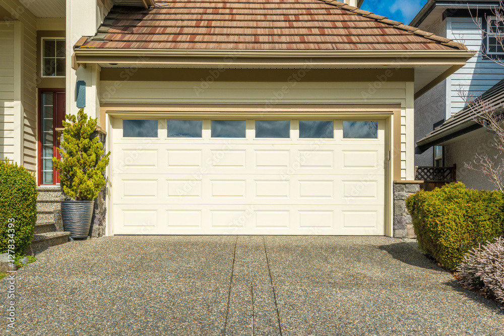 Naklejka premium Fragment of a luxury house with a garage door in Vancouver, Canada.