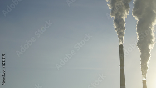 industrial chimneys emits toxic pollutants into the sky polluting the environment.