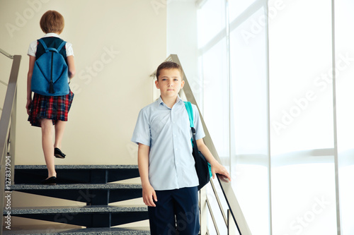 Cute schoolkids on staircases
