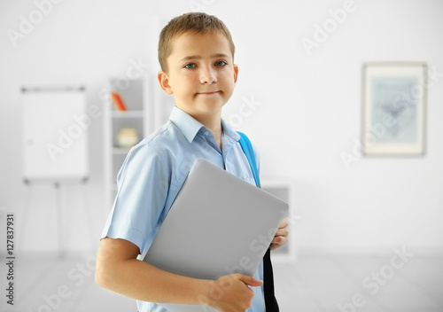 Cute schoolboy with laptop ...