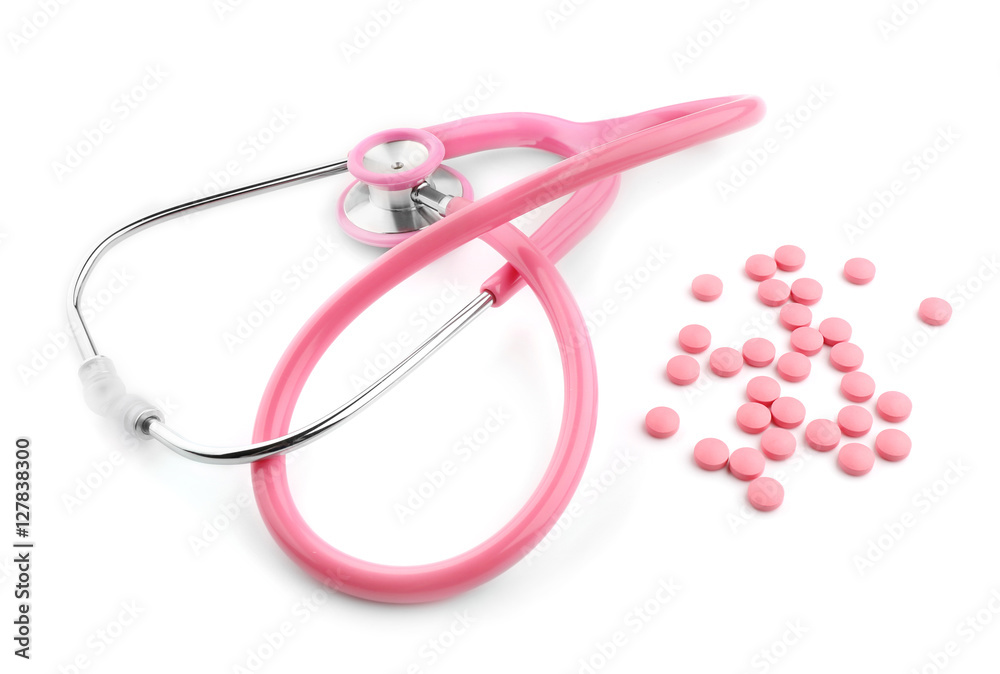 Fototapeta premium Pink stethoscope and pills isolated on white