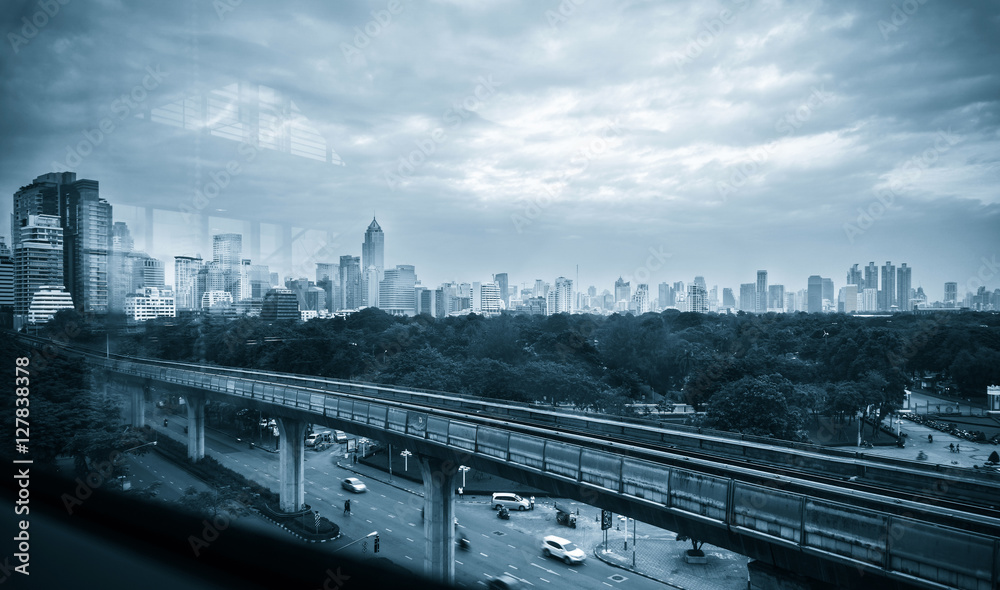 Abstract Background : The view through the glass  Bangkok City with electric Sky train rail On Top of the road