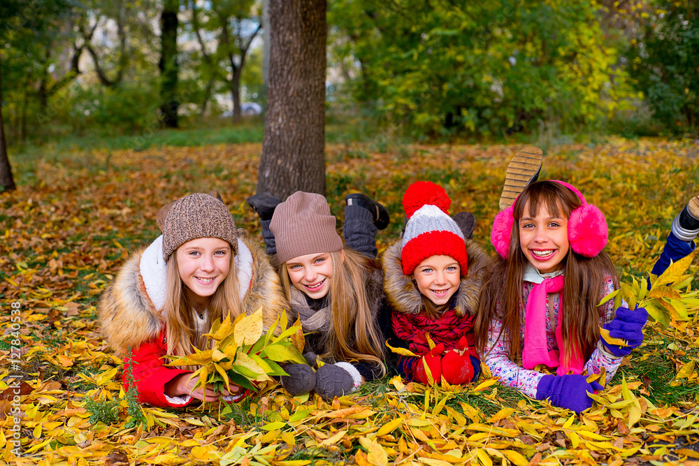 group of girls in autumn park with leafs group of girls in autumn park with leafs