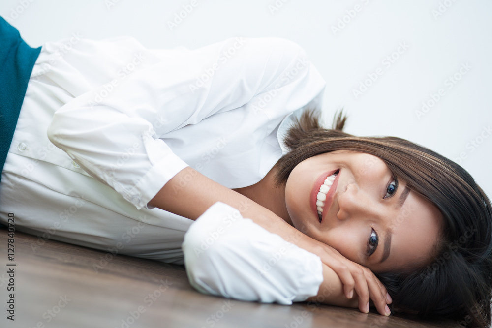 Cheerful Asian businesswoman resting on floor Cheerful Asian businesswoman resting on floor