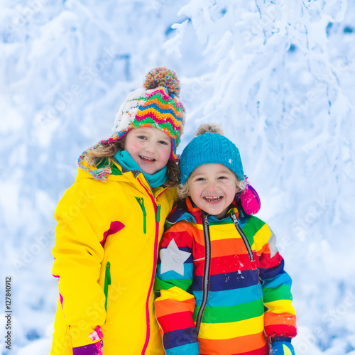 Kids play with snow in winter park