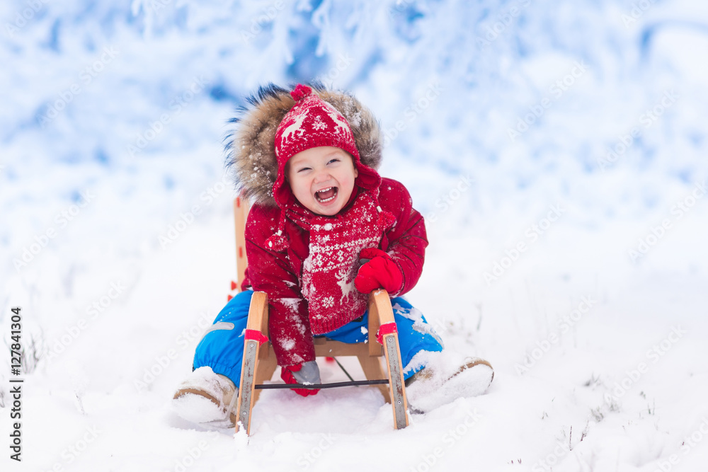 Kids play in snow. Winter sleigh ride for children