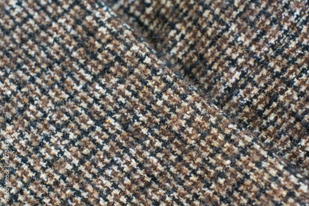 Fototapeta premium Wool or Tweed texture background. Fabric checkered in brown. Selective focus.
