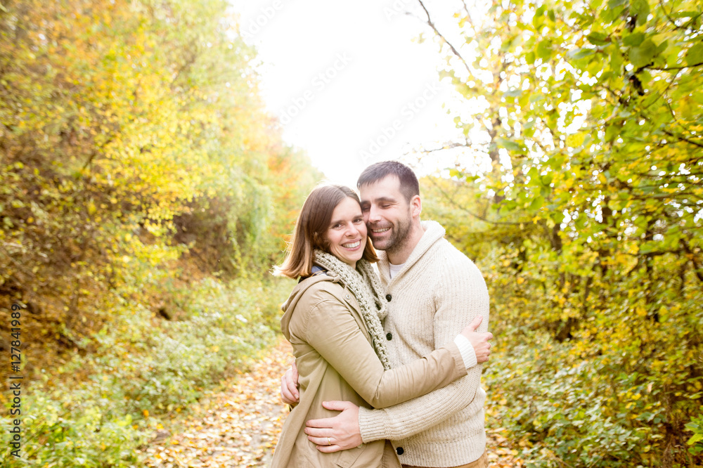 Beautiful young couple on a walk in colorful autumn nature. Beautiful young couple on a walk in colorful autumn nature.
