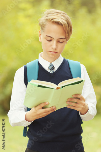 Handsome teenager with book...