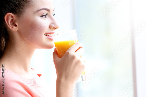 Young beautiful  woman drinking juice
