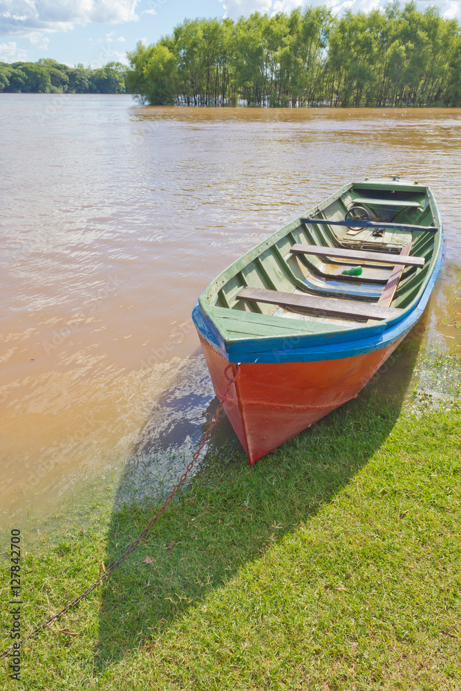 Wood boat during a flood at Rio Pardo river